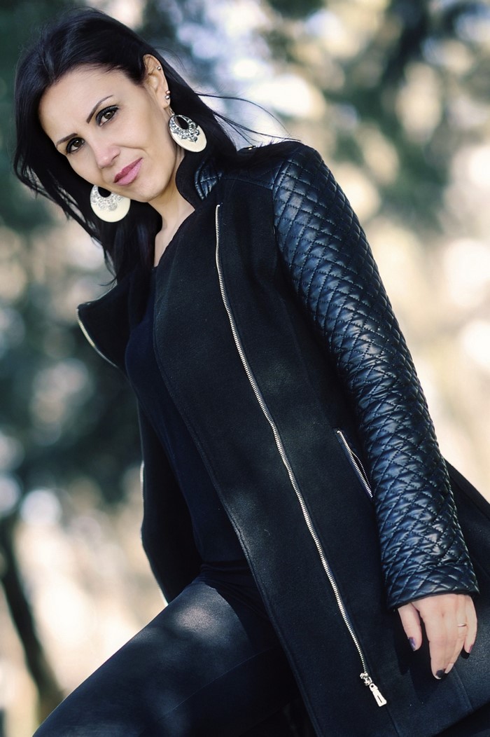 Woman with black hair wearing a black jacket