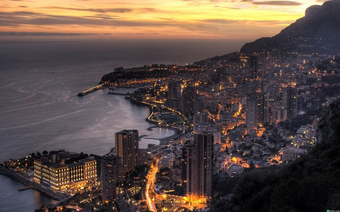 Cityscape of Monaco at sunset with sea and mountains