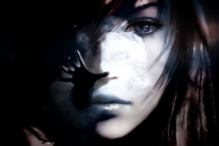 Close-up of a woman's face with a hand reaching out