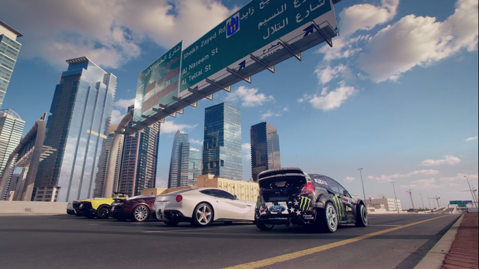 Ken Block's Ford Fiesta and other sports cars on a highway in Dubai