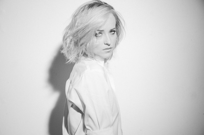 Dakota Johnson in a white shirt, black and white portrait