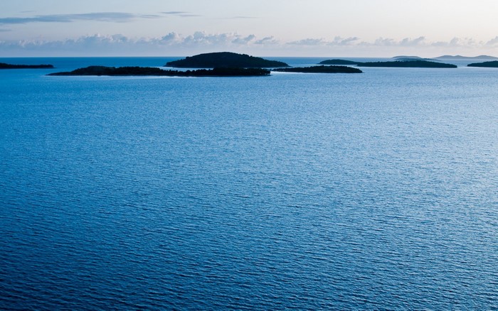 Islands in the blue sea under a cloudy sky