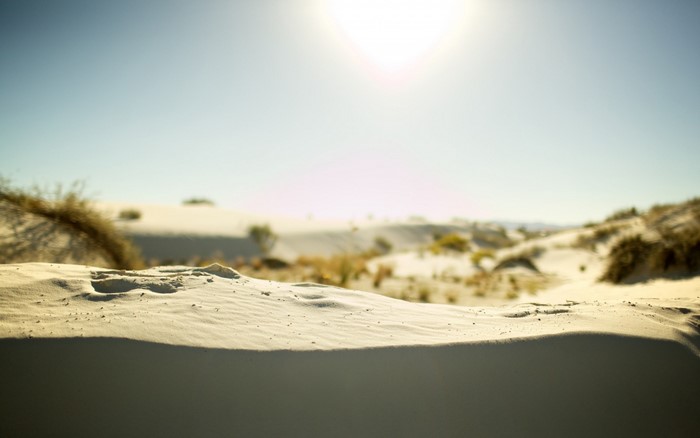 Sunlight over sand dunes in a desert landscape