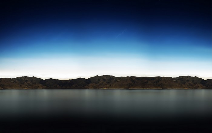 Mountain range reflected in a lake at dusk