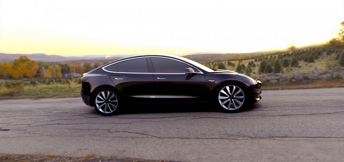 Dark Tesla Model 3 Sedan on a Road