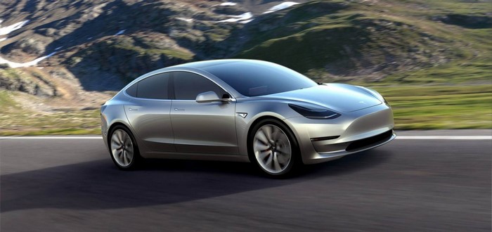 Silver Tesla Model 3 driving on a mountain road