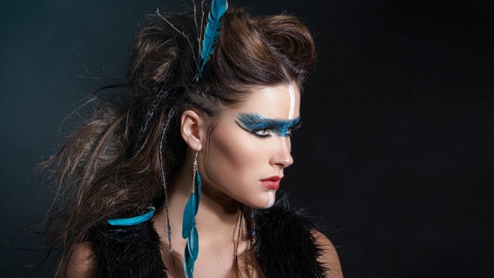 Woman with blue feather makeup and hairstyle