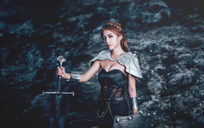 Woman in Black Dress Holding Sword with Shield