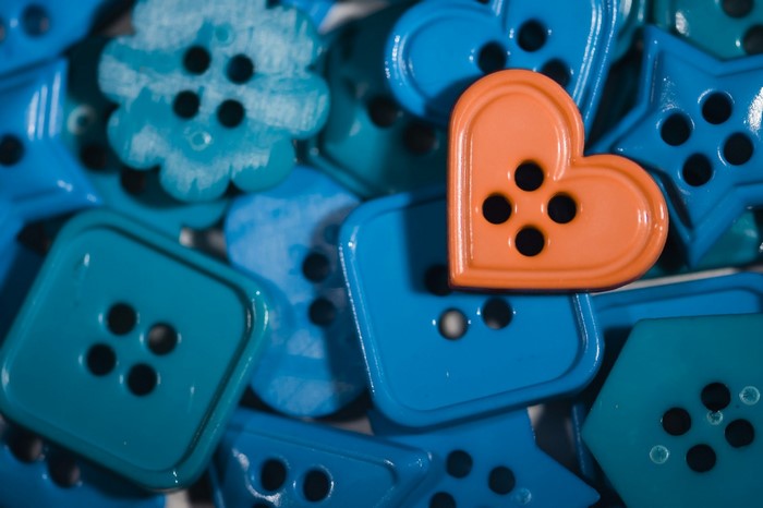 Orange heart button among blue buttons