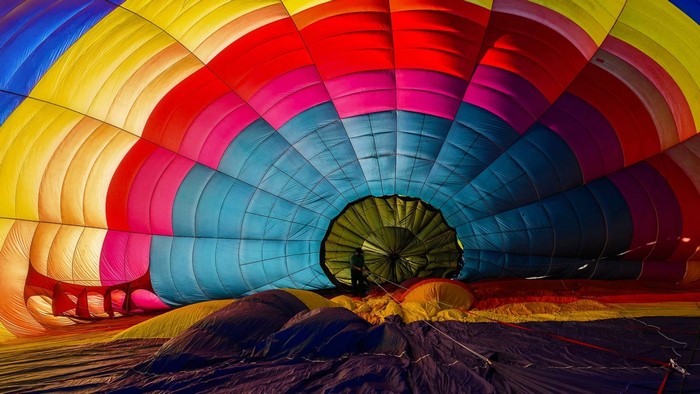 Inside a colorful hot air balloon with a person