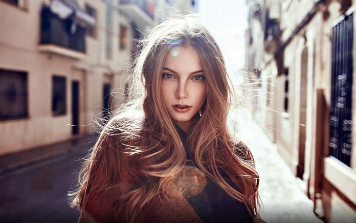 Woman with long blonde hair in a street