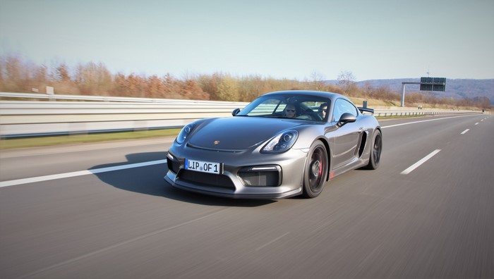 Porsche Cayman GT4 driving on a highway