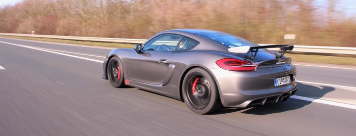 Porsche Cayman GT4 driving on a highway