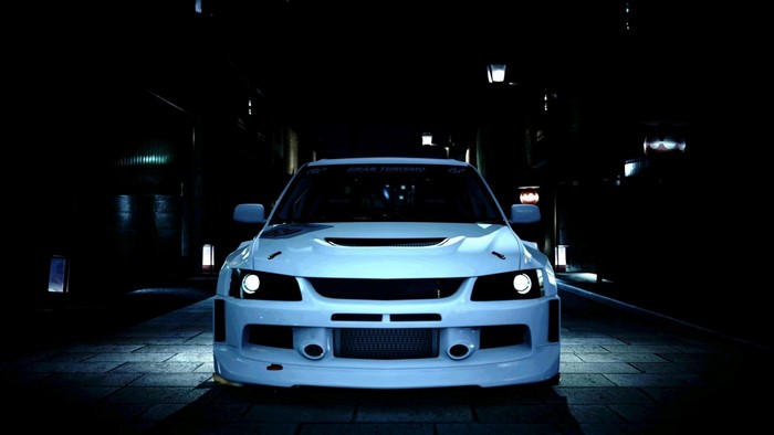 White Mitsubishi Lancer Evolution parked at night