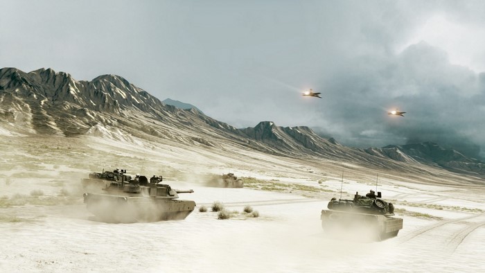Tanks and jets in a desert mountain landscape