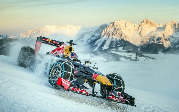 Red Bull Formula 1 car with snow chains on a snowy mountain