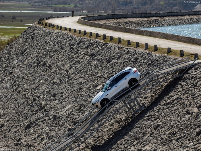 Silver Jaguar F-Pace driving on a steep ramp
