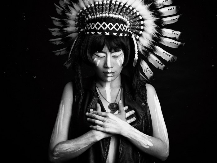 Woman with Native American headdress and face paint