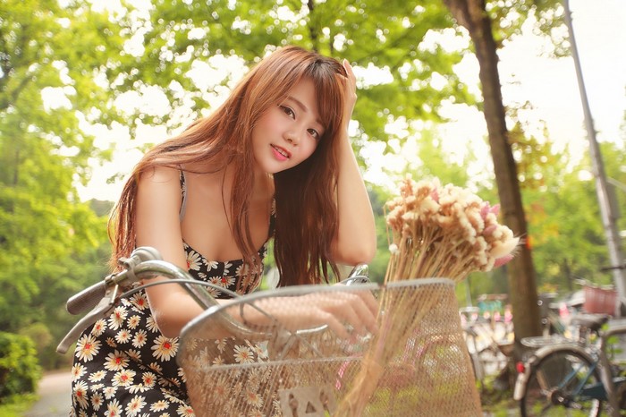 Asian woman with long hair on a bicycle