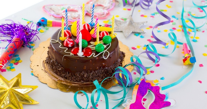 Birthday cake with candles and party decorations