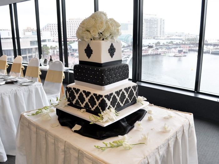 Black and white tiered wedding cake with flowers