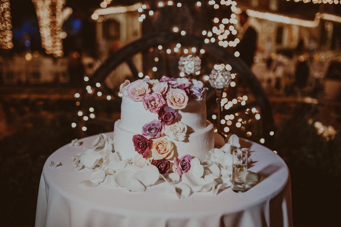 Wedding cake with flowers and bokeh lights