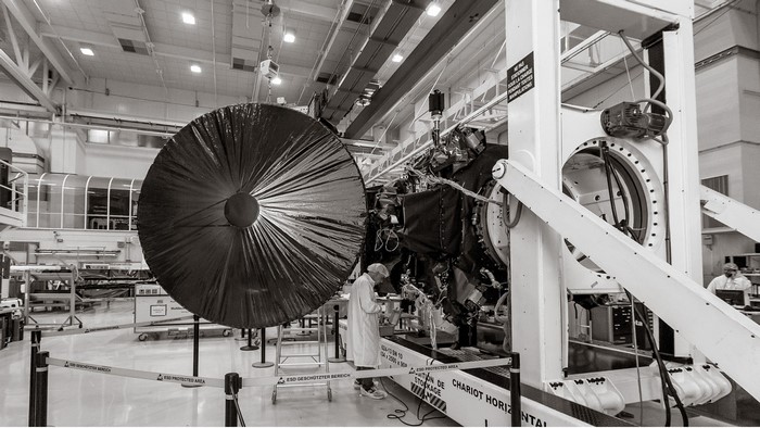 Spacecraft assembly in a cleanroom with large dish antenna