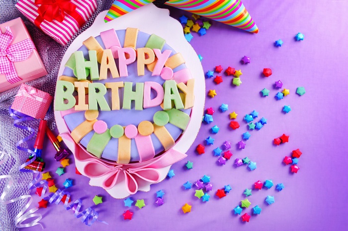 Birthday cake with gifts and party decorations