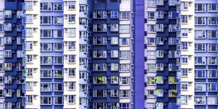 Apartment building facade with many windows and balconies
