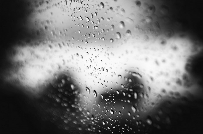Monochrome photography of water drops on glass