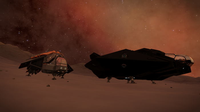 Two spaceships on a rocky, orange planet with a nebula in the sky