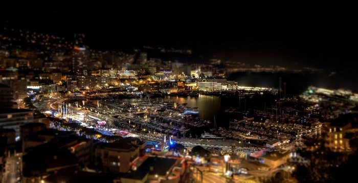 Night cityscape of a harbor with many boats and buildings