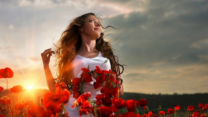 Woman in White Dress Among Poppies at Sunset
