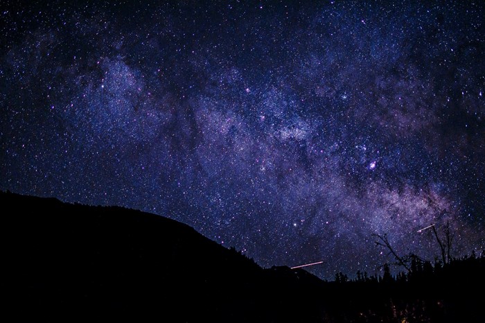 The Milky Way galaxy over a silhouetted mountain range