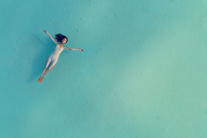 Woman floating in turquoise water