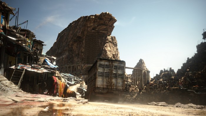 Post-apocalyptic settlement with a large truck and rocky mountains