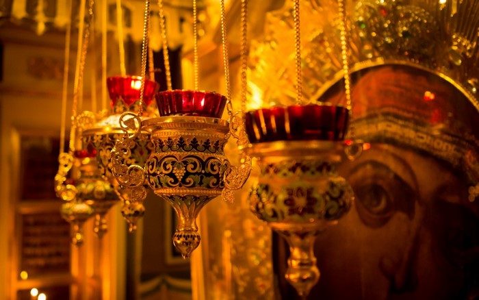 Hanging Orthodox church lamps with icon in background