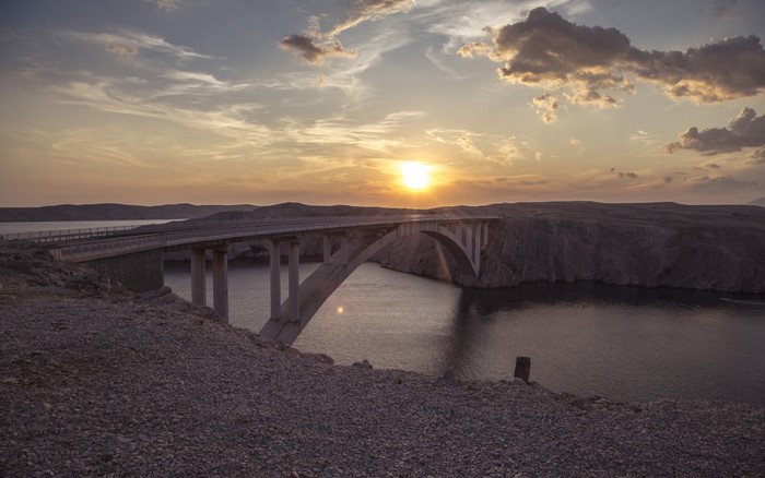 Bridge over water at sunset