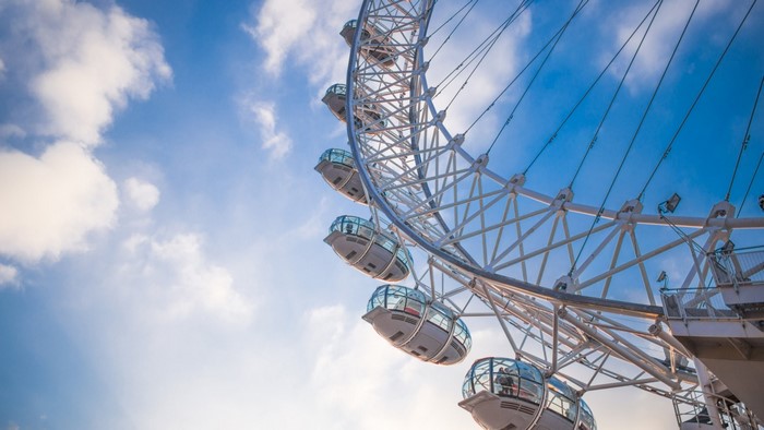 London Eye Ferris Wheel against a cloudy blue sky