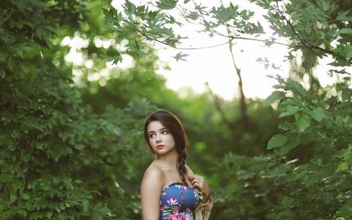 Woman in floral dress in a forest