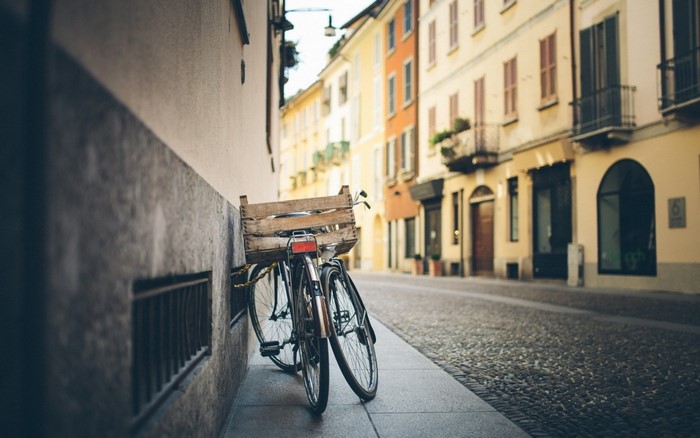 Bicycle with wooden crate parked on a cobblestone street