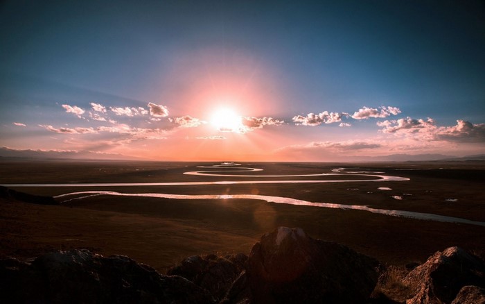 Sunset over a winding river landscape
