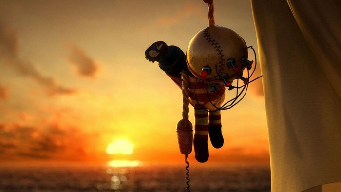 Creepy doll hanging at sunset over the sea