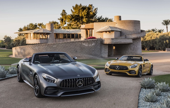 Two Mercedes-AMG GT C Roadsters in front of a modern house