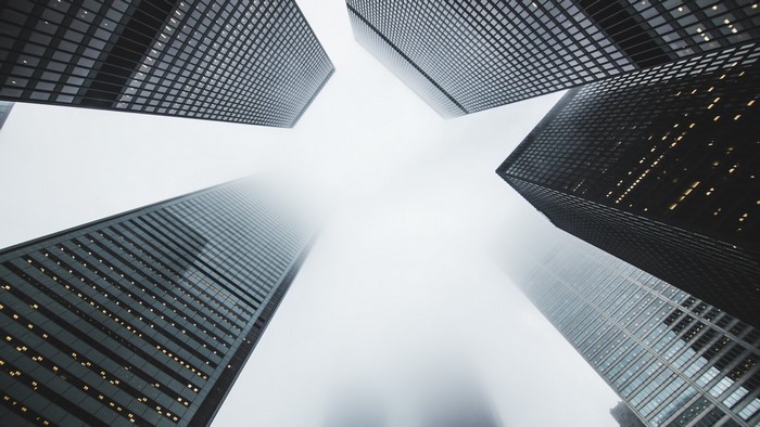 Skyscrapers viewed from below in the mist