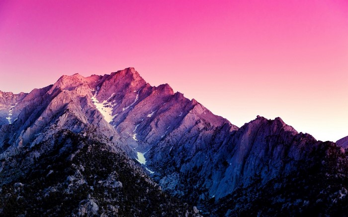 Mountain range at sunrise with pink and purple sky