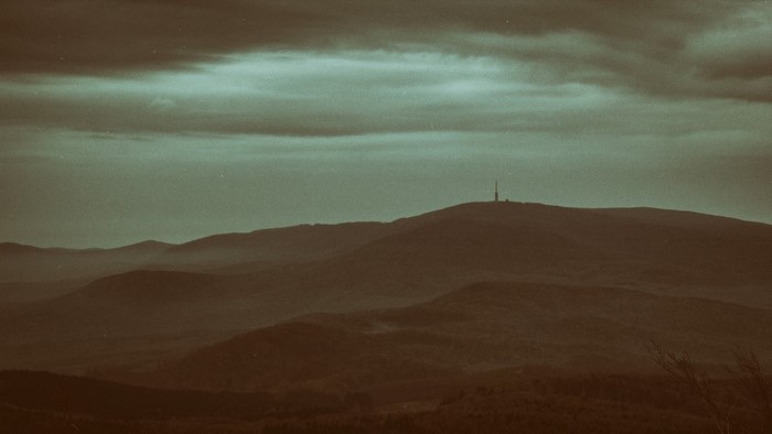 Misty mountains with a tower on the horizon