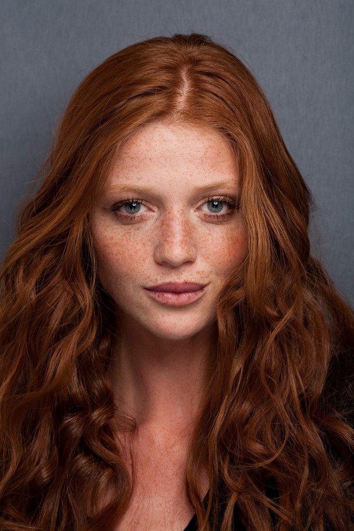 Portrait of Redhead Woman with Freckles and Wavy Hair