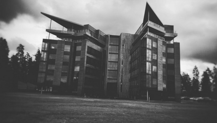 Modern building with unique architecture against a cloudy sky