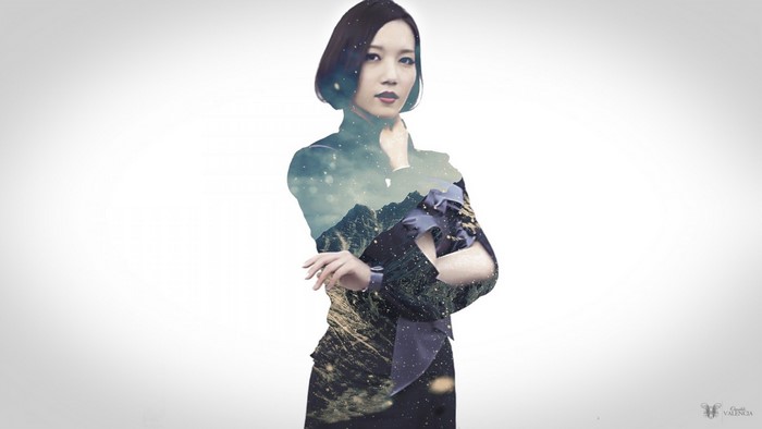 Woman with double exposure of mountains and stars